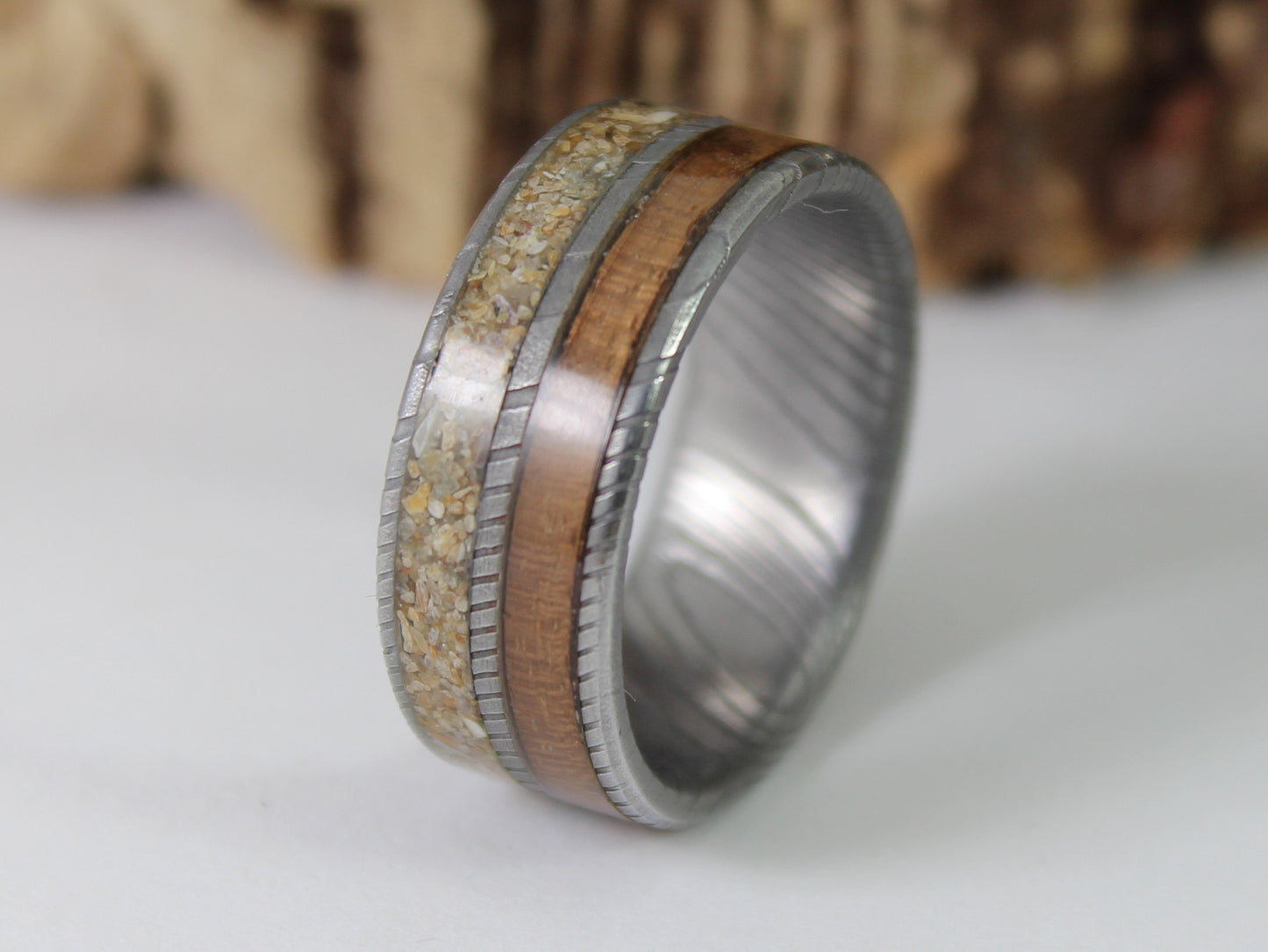 Damascus steel ring with Walnut taken from a WW2 Lee Enfield rifle and sand from Normandy.