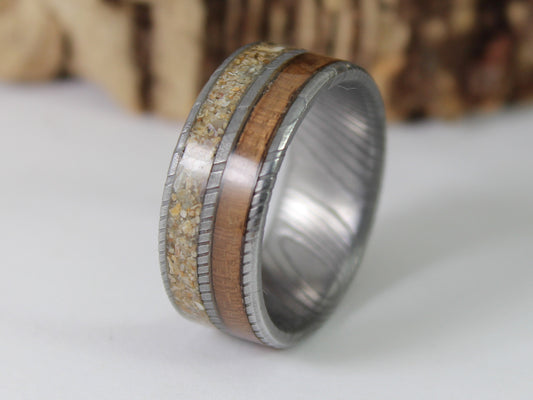 Damascus steel ring with Walnut taken from a WW2 Lee Enfield rifle and sand from Normandy.