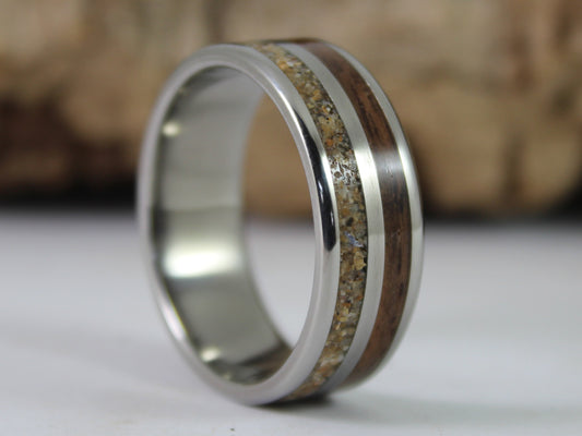 A sterling silver ring with inlays of walnut wood from a WW2 rifle and sand from Normandy landing beaches